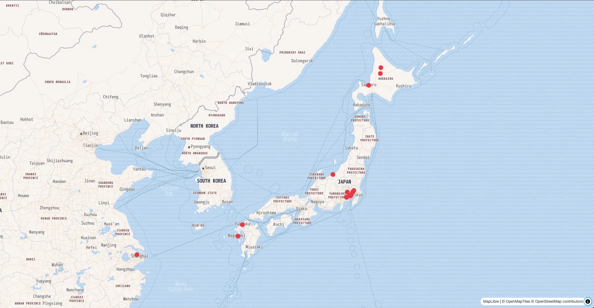 A map rendered with MapLibre GL JS showing GeoJSON retrieved from Public API, with red circle markers scattered across Japan.
